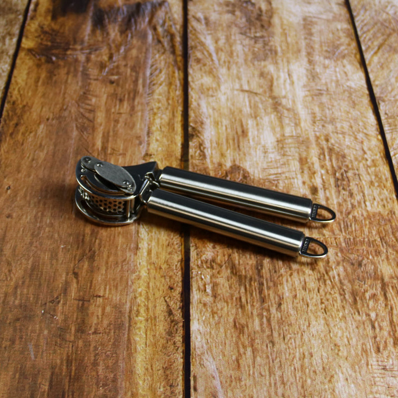 Cristel Garlic press with scaper on Wood Table