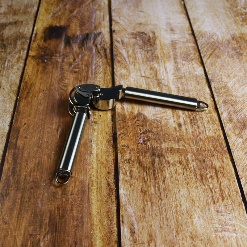 Cristel Opened Garlic press with scaper on Wood Table